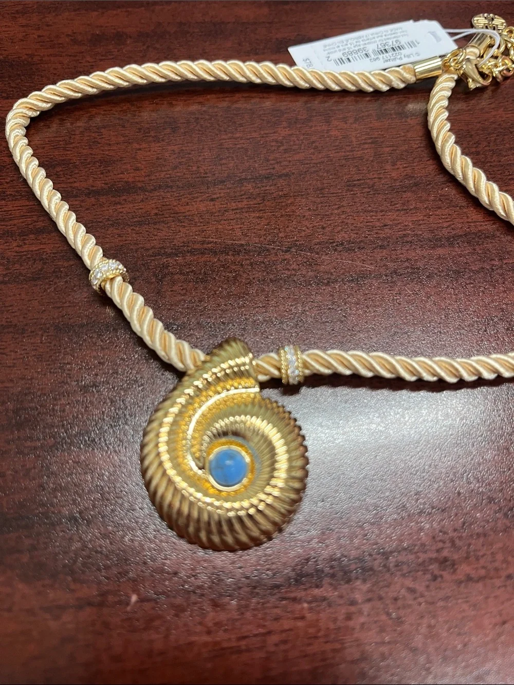 Lilly Pulitzer gold shell with blue stone! Gold cord with accents. Beautiful.